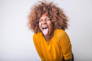 Tongue out yellow shirt